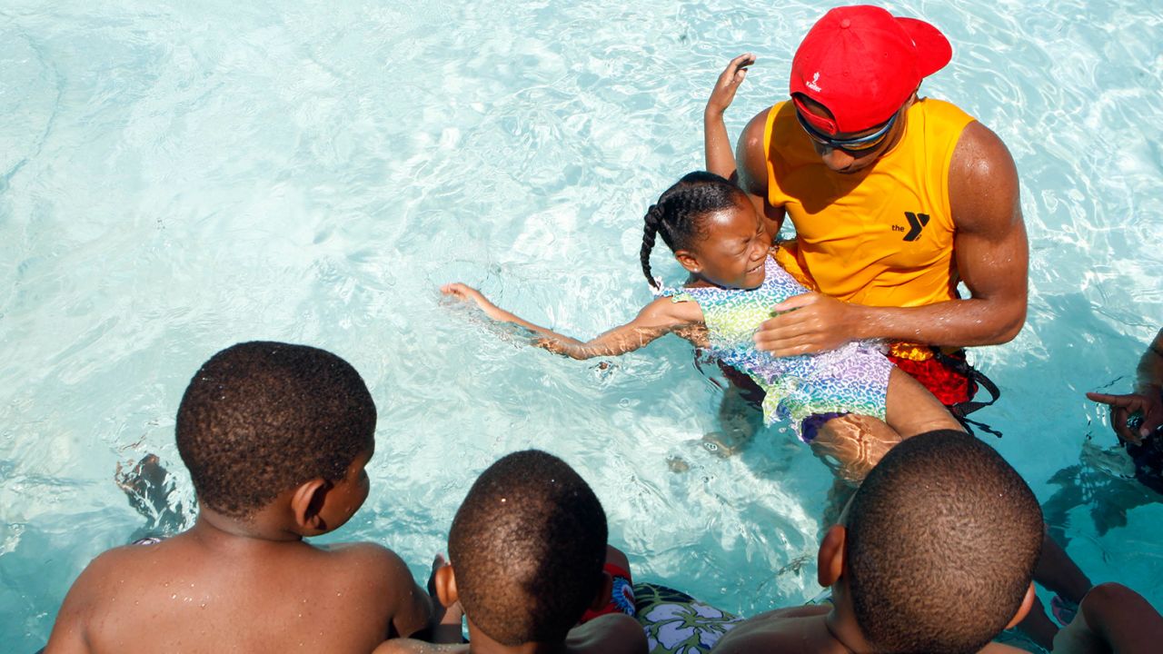 Children get a swimming lesson at a YMCA in Memphis, Tennessee.  Research shows participation in formal swimming lessons can reduce the risk of drowning. 