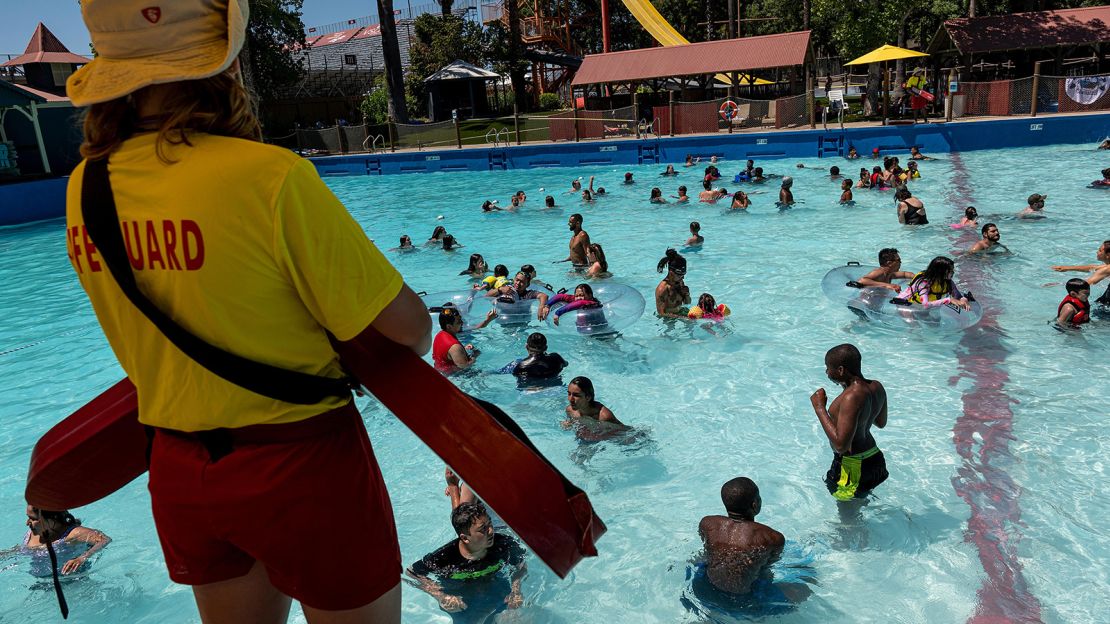 A lifeguard watches visitors swim at the Raging Waters Sacramento water park at Cal Expo in Sacramento, California. There's a shortage of guards this year, so be extra vigilant.