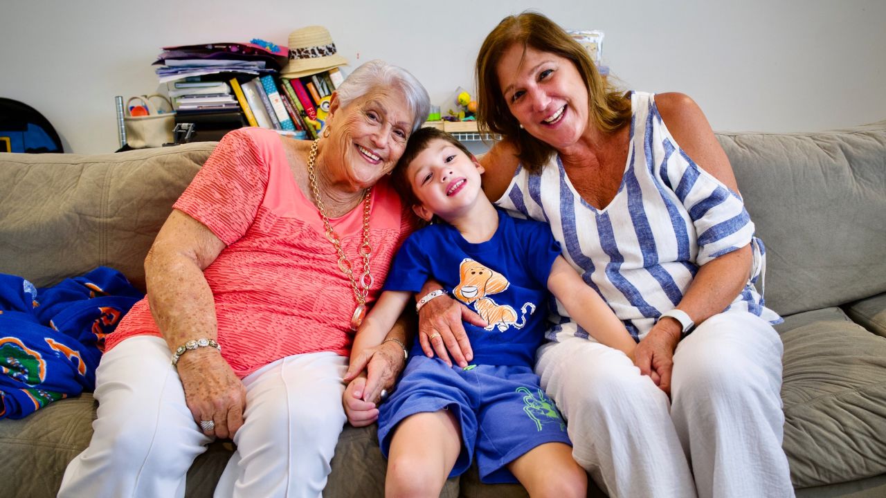 John Rodriguez snuggles with Elena Chavez, left, and Elena Chavez Blasser.