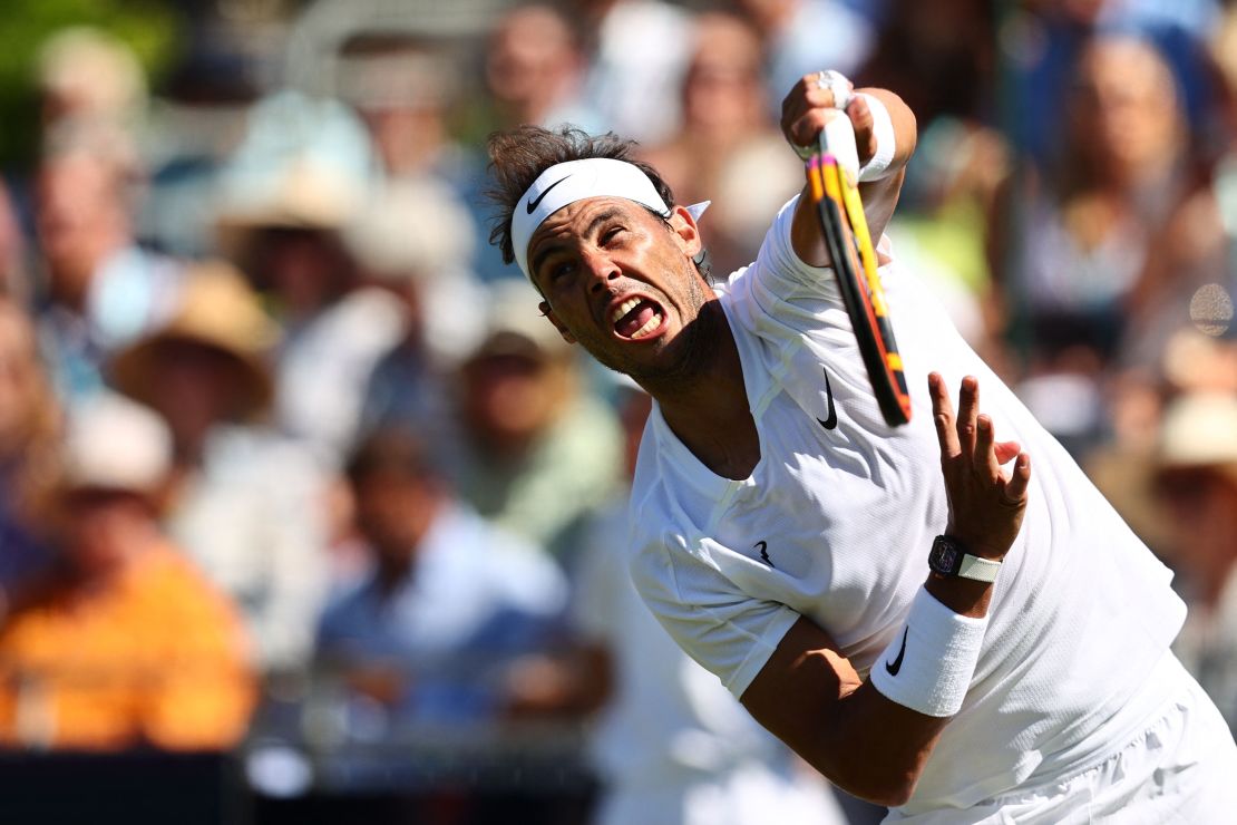 Nadal hits a serve during an exhibition match against Stan Wawrinka at the Hurlingham Club in London.