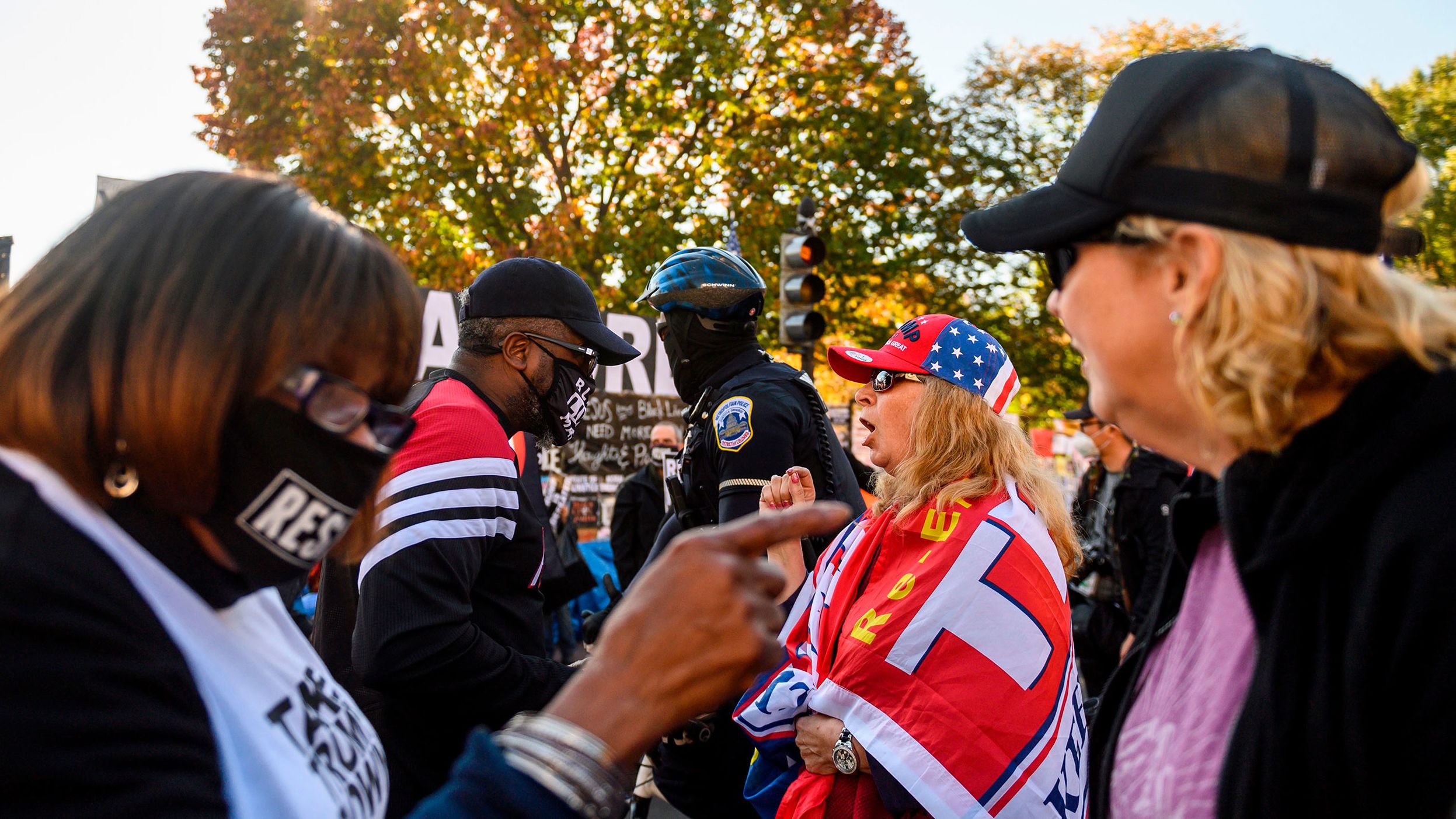 Supporters of Donald Trump and Joe Biden argue in front of the White House in Washington, DC, on November 13, 2020.