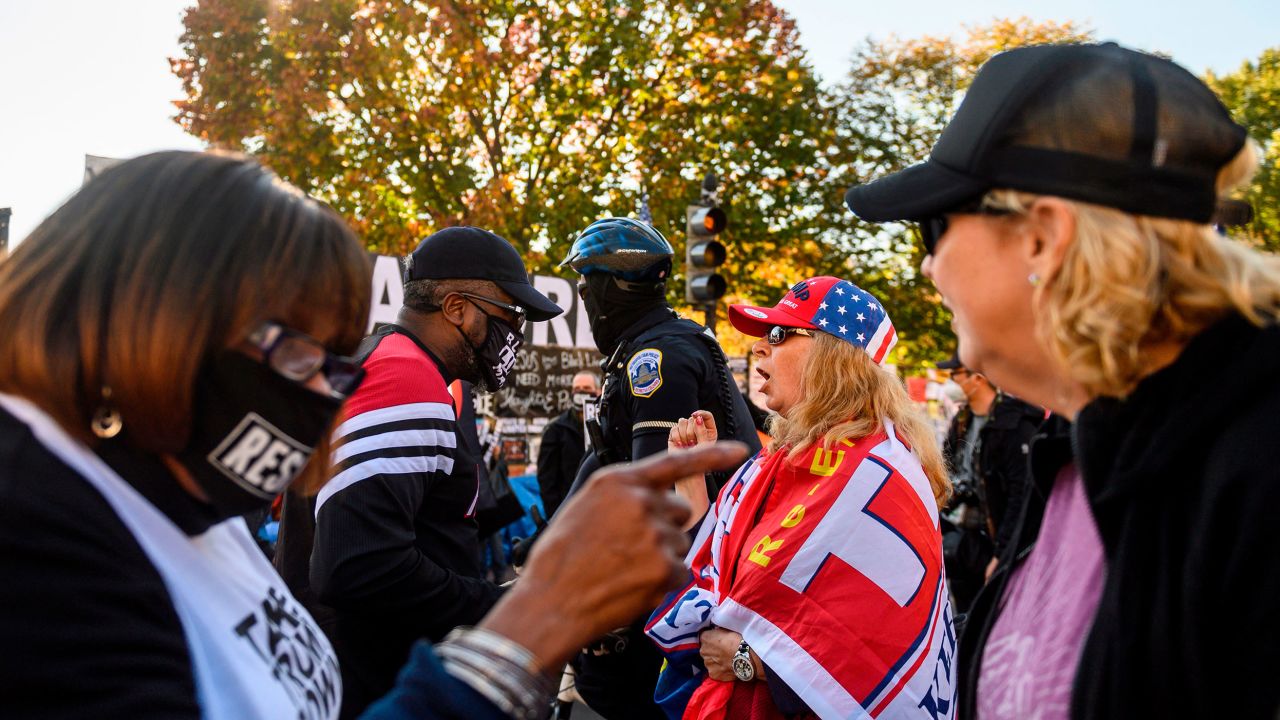 Supporters of Donald Trump and Joe Biden argue in front of the White House in Washington, DC, on November 13, 2020.