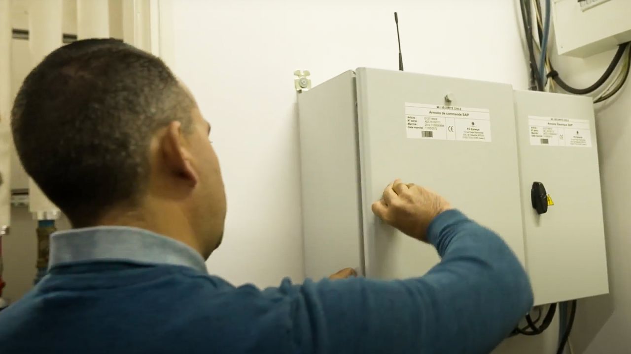 Stéphane Mollet, a technician at Maison Laffitte's town hall, opens a cabinet containing alert electronics.
