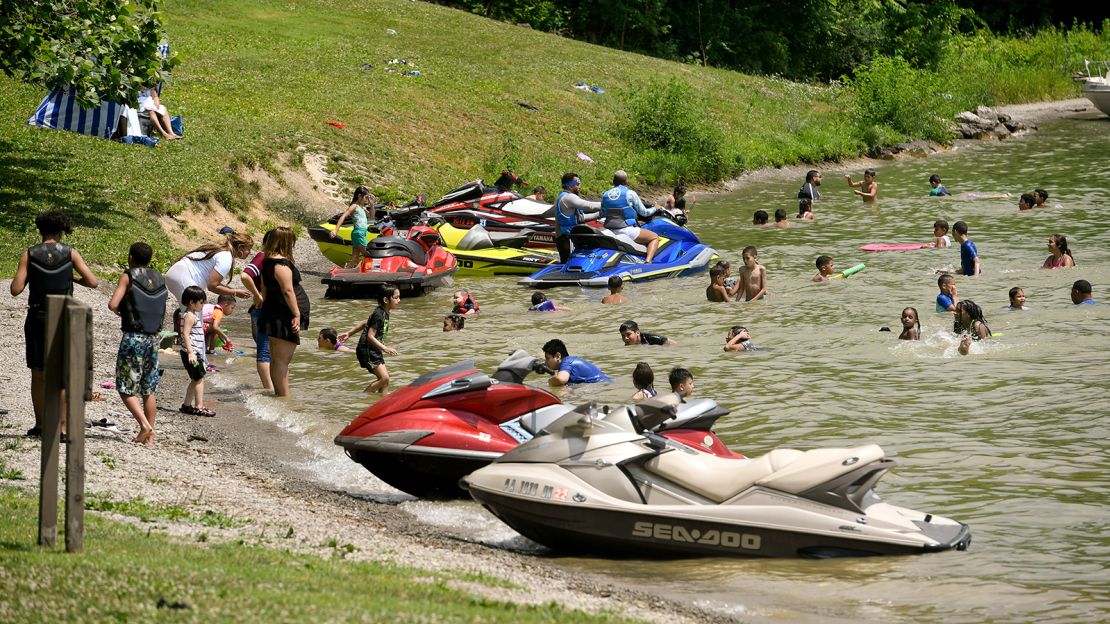 Personal watercraft hug the shoreline at Blue Marsh Lake near Reading, Pennsylvania. In that state, you need a Boating Safety Education Certificate in your possession to operate one. The US Coast Guard says you should wear torso-protecting life jackets while riding one. Also, don't jump wakes and don't drink alcohol before operating.