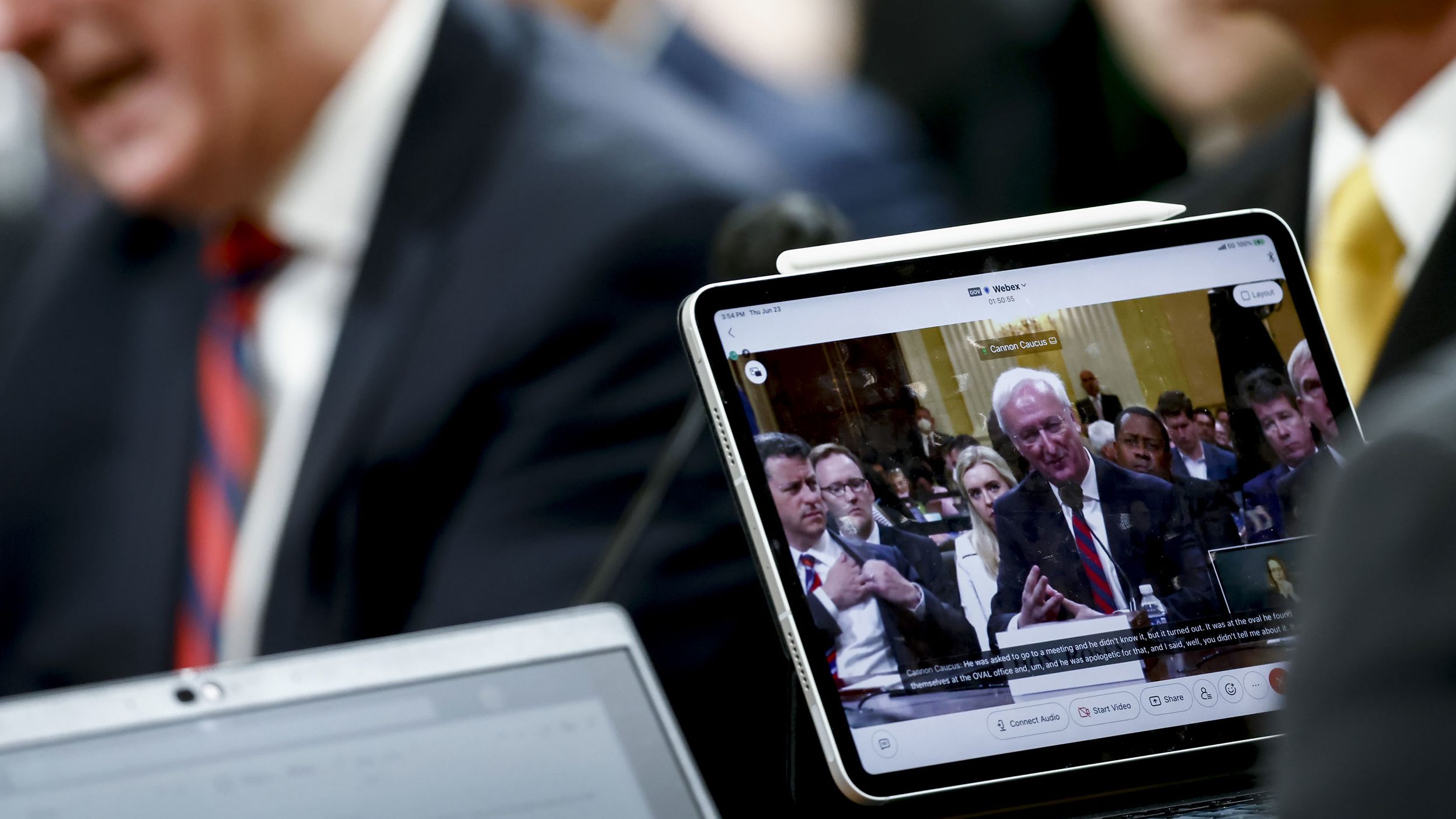 Rosen is displayed on a monitor while testifying on June 23.