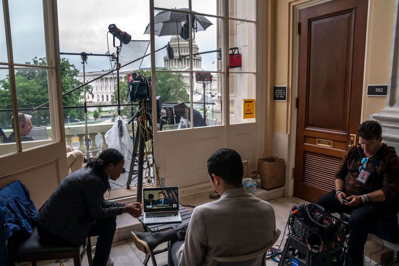 Journalists watch the June 23 hearing on a laptop outside the hearing room.