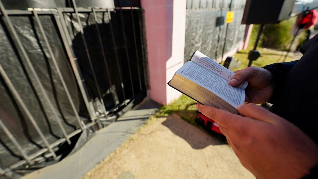 Gabriel Oliver, who opposes abortion rights,  reads from the Bible outside of an abortion clinic in Jackson, Mississippi, on December 1, 2021. 