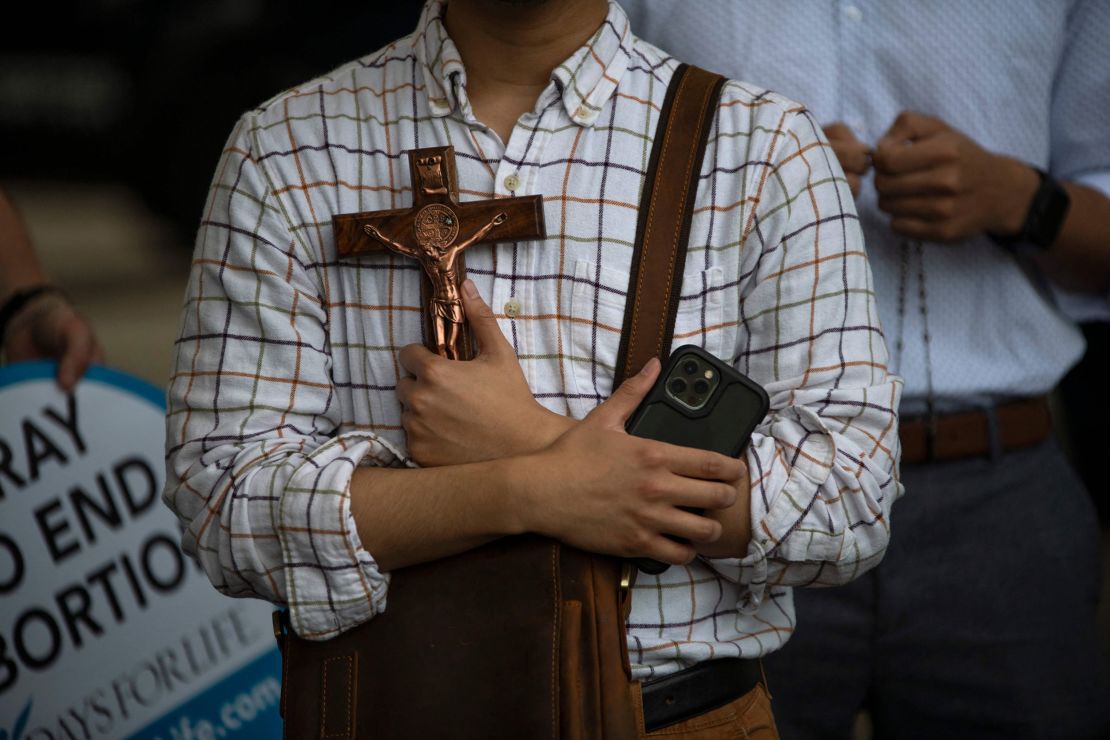 Anti-abortion protesters pray as demonstrators gather outside the Houston, Texas, City Hall during a Bans Off Our Bodies rally on May 14, 2022. 