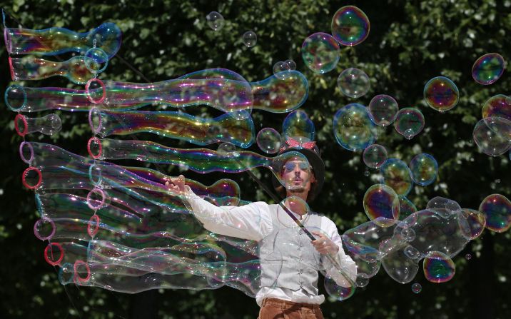 A street artist blows bubbles during a performance in Paris on Friday, June 17. A <a href="https://www.cnn.com/2022/06/16/europe/france-temperature-record-heatwave-intl/index.html" target="_blank">heatwave</a> is sweeping across much of France and Europe. 
