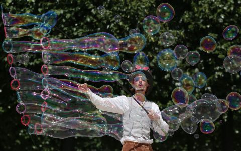 A street artist blows bubbles during a performance in Paris on Friday, June 17. A <a href=