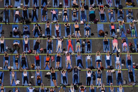 Yogis take part in the 'Times Square: Mind Over Madness Yoga' event marking the summer solstice, in Times Square, New York on Tuesday, June 21.