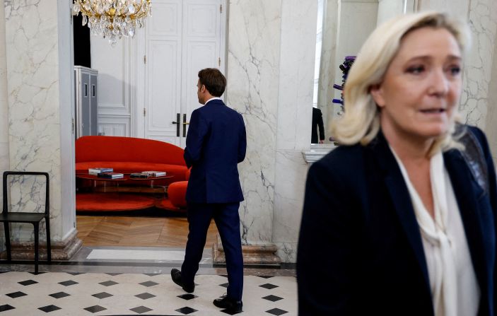 French far-right National Rally leader and member of parliament Marine Le Pen walks away after being escorted by French President Emmanuel Macron after talks at the presidential Élysée Palace on Tuesday, June 21.