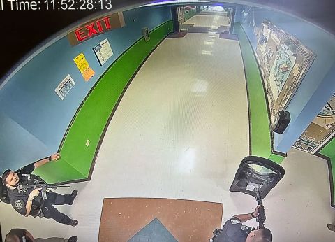 An image obtained by the Austin-American Statesman shows at least three officers in the hallway of Robb Elementary at 11:52 a.m, 19 minutes after a gunman entered the school, killing 19 children and two teachers. One officer has what appears to be a tactical shield, and two of the officers hold rifles. The Uvalde mayor has criticized the current investigations and <a href=