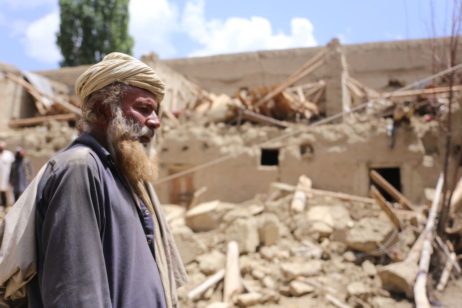 A man stands near debris of a building after the quake shakes border provinces of Paktika, Afghanistan on June 23.