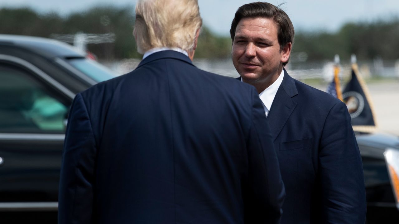 US President Donald Trump is greeted by Florida Governor Ron DeSantis at Southwest Florida International Airport October 16, 2020, in Fort Myers, Florida. (Photo by Brendan Smialowski / AFP) (Photo by BRENDAN SMIALOWSKI/AFP via Getty Images)