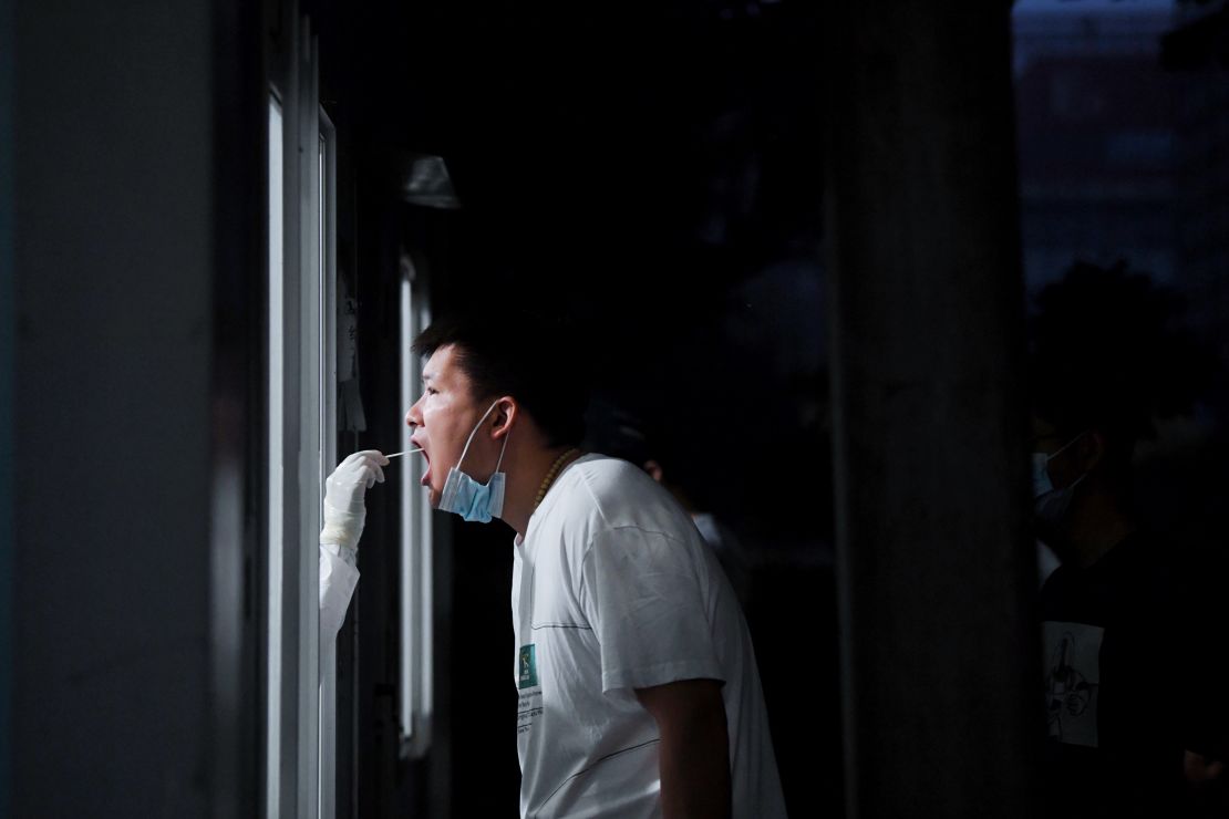 A medical worker takes a swab sample for Covid-19 from a citizen on June 22, 2022 in Beijing, China.