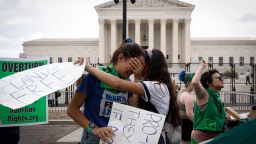 WASHINGTON, DC - JUNE 24:    Abortion rights activists Carrie McDonald  (L) and Soraya Bata react to the Dobbs v Jackson Women's Health Organization ruling which overturns the landmark abortion Roe v. Wade case in front of the U.S. Supreme Court on June 24, 2022 in Washington, DC.  