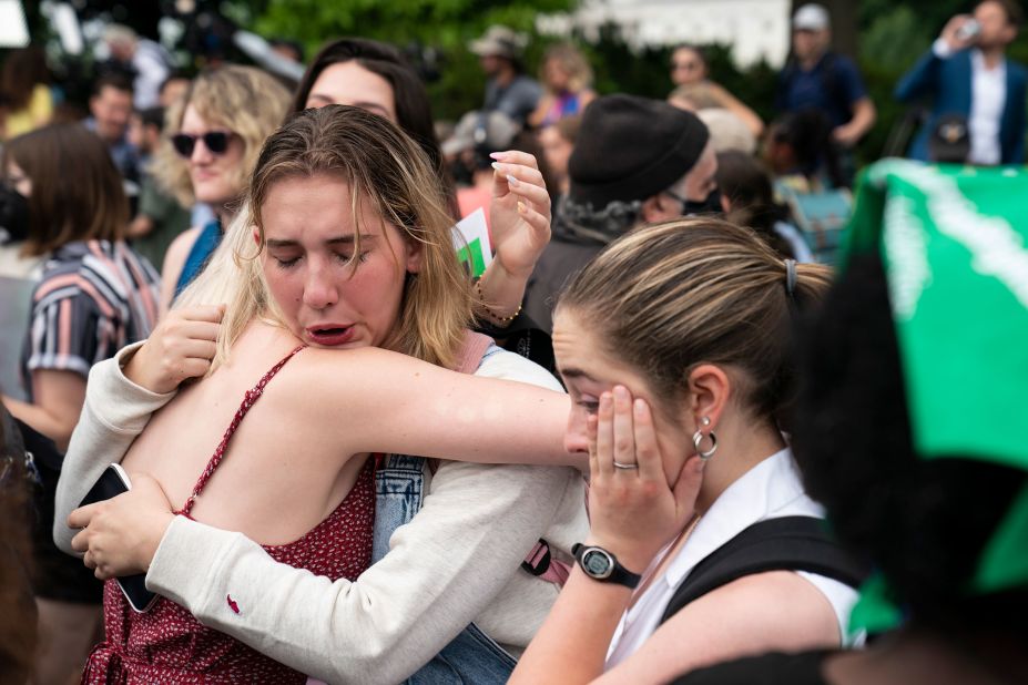 Abortion rights advocates hug outside the Supreme Court on Friday.