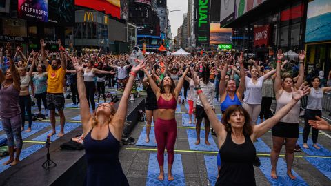 Yogis take part in a summer solitice event in Times Square on Tuesday.
