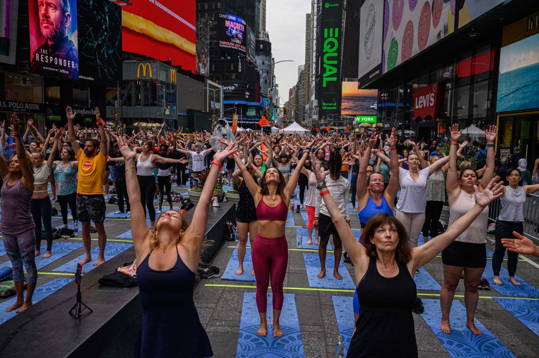 Yogis take part in a summer solitice event in Times Square on Tuesday.