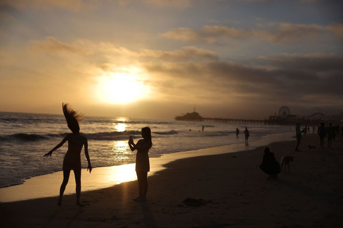 Women dance on the beach in Santa Monica, California earlier this week.