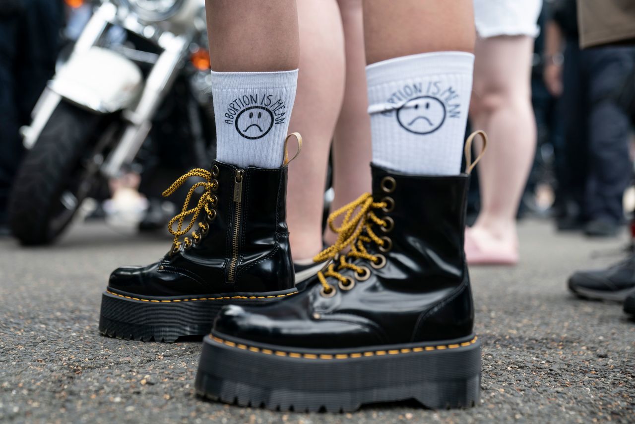 Socks that read "abortion is mean" are worn by an anti-abortion activist outside of the Supreme Court on Friday.
