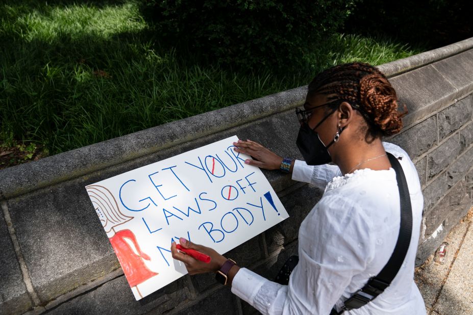 A woman creates an abortion rights poster on Friday in Washington, DC.