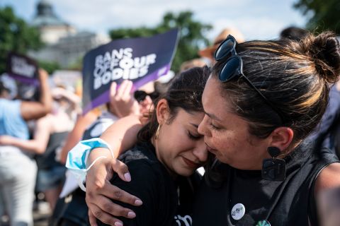 Abortion rights protesters embrace outside the Supreme Court on Friday.