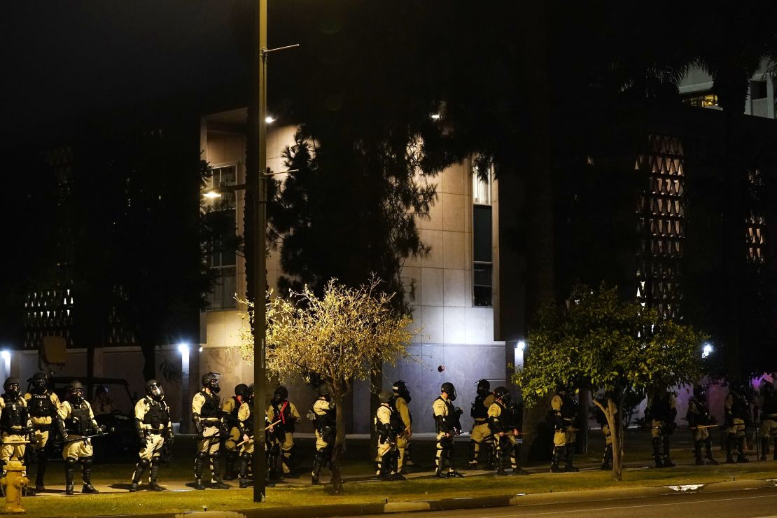 Riot police surround the Arizona Capitol after protesters reached the front of the Arizona Senate building following the Supreme Court's decision to overturn Roe v. Wade on Friday.