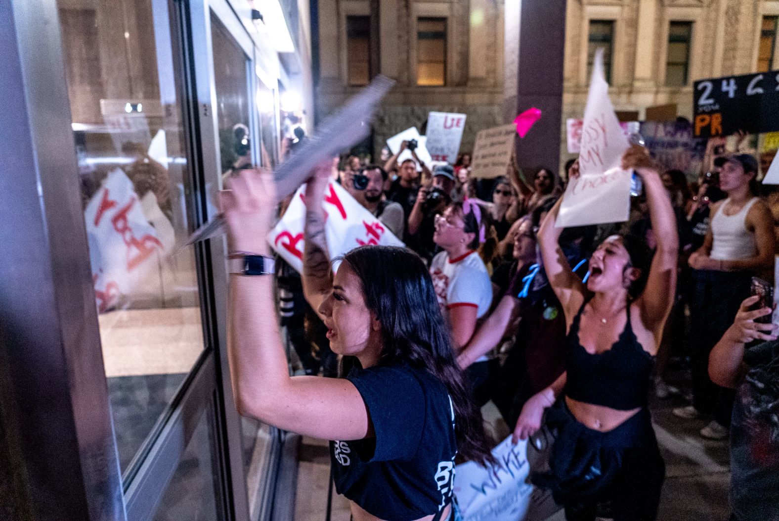 Abortion rights activists pound on the doors of the Arizona State Senate late Friday, June 24. <a  target="_blank">Law enforcement used tear gas</a> to disperse the crowd.