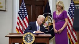 U.S. President Joe Biden signs S. 2938: Bipartisan Safer Communities Act into law from the Roosevelt Room at the White House as first lady Jill Biden stands next to him in Washington, U.S., June 25, 2022.