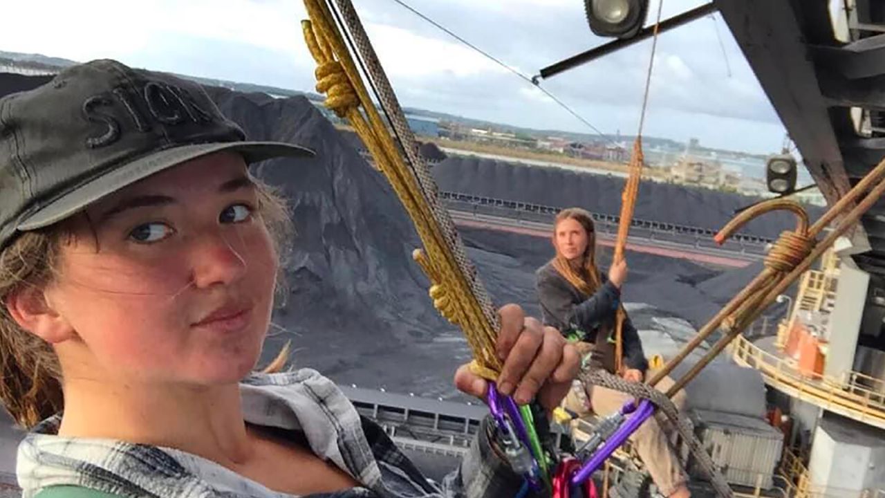 Zianna Fuad (right) and another member of Blockade Australia abseiled off a coal loader at Newcastle in November 2021.  