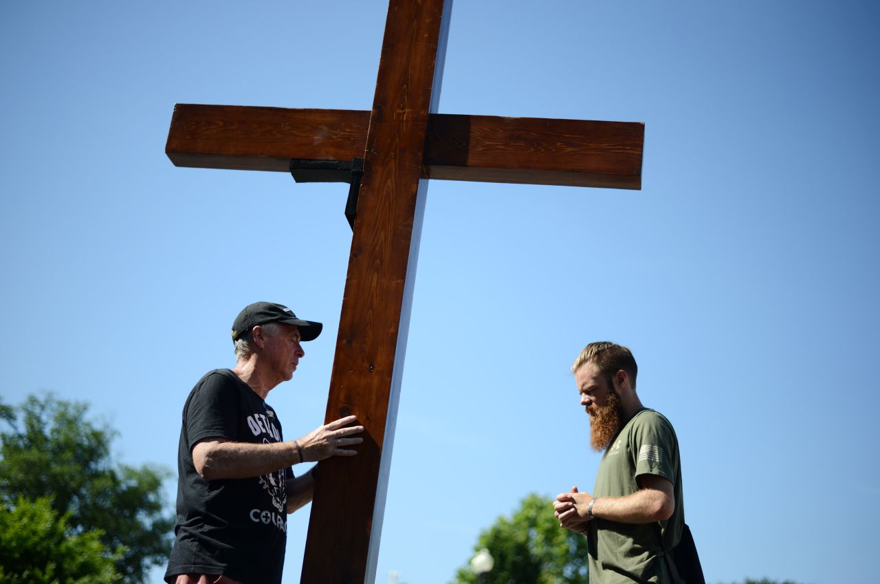 Two anti-abortion activists brought a large wooden cross for a prayer near the Supreme Court on Saturday in Washington, DC.