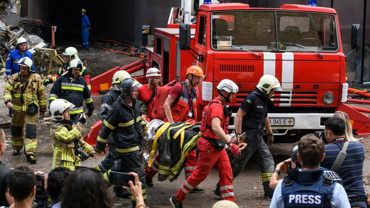 Rescuers evacuate a person from an apartment building destroyed in a Russian airstrikes in the Shevchenkivskiy district of Kyiv on June 26, 2022.