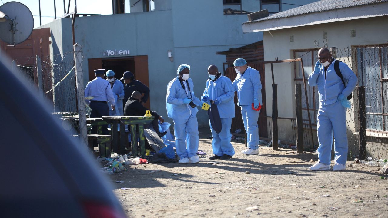 Forensic personnel investigate after the deaths of patrons found inside the Enyobeni Tavern, in Scenery Park, outside East London in the Eastern Cape province, South Africa, June 26, 2022.