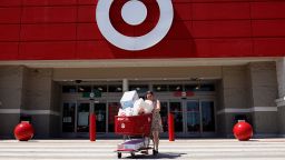 A customer exits from a Target store on May 18, 2022 in Miami, Florida.  The retail store reported a 52% drop in profit for the first quarter, missing Wall Street's forecasts. The company blamed higher expenses due to continued supply chain disruptions as well as the high inflation rate. 