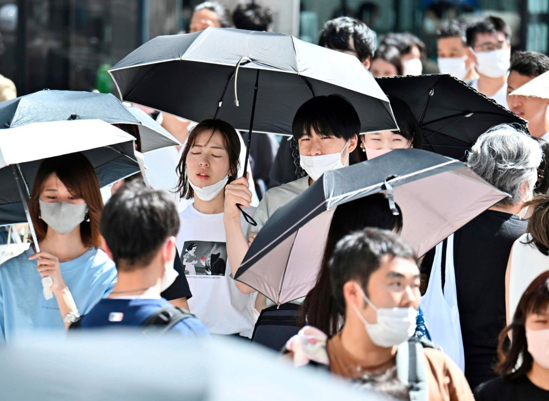 People wearing face masks are seen at Ginza district in Tokyo on June 26, 2022. 