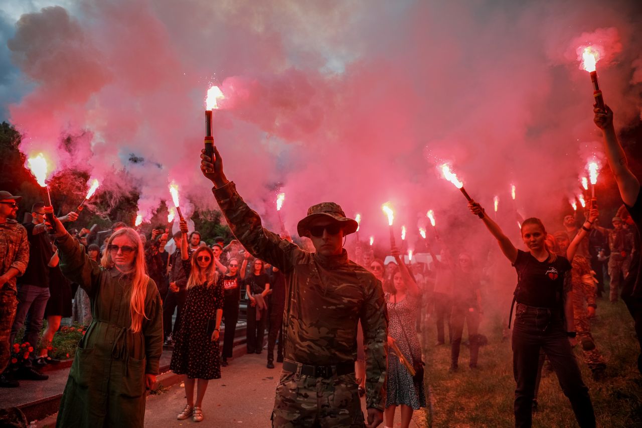 People light flares in memory of the Ukrainian activist Roman Ratushnyi during a farewell ceremony at Baikove cemetery, Kyiv, Ukraine, on June 18.  Zelensky says Russia waging war so Putin can stay in power &#8216;until the end of his life&#8217; 220627081904 01 ukraine gallery update