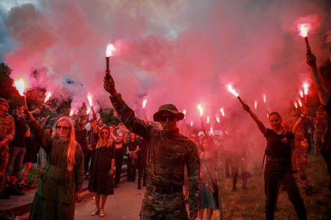 People light flares in memory of the famous Ukrainian activist Roman Ratushnyi during a farewell ceremony on Baikove cemetery, Kyiv, Ukraine, on June 18.