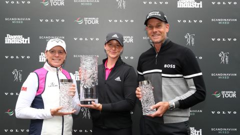 Grant is presented with the Scandinavian mixed trophy by tournament hosts Annika Sorenstam and Henrik Stenson.