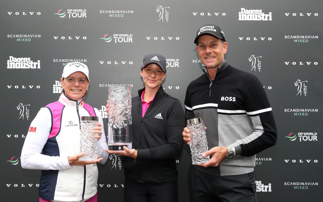 Grant is presented with the Scandanavian Mixed trophy by tournament hosts Annika Sorenstam and Henrik Stenson.