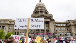 An attendee at Planned Parenthood's Bans Off Our Bodies rally for abortion rights holds a sign reading "Idaho the women as property state" outside of the Idaho Statehouse in downtown Boise, Idaho, on Saturday, May 14, 2022. (Sarah A. Miller/Idaho Statesman via AP)