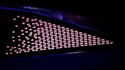 During the day, this grid of triangles inside the door of the Cadillac Lyriq looks like metal over metal. At night, colored light glows through the thin metal backing.