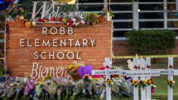UVALDE, TEXAS - MAY 26: A memorial is seen surrounding the Robb Elementary School sign following the mass shooting at Robb Elementary School on May 26, 2022 in Uvalde, Texas. According to reports, 19 students and 2 adults were killed, with the gunman fatally shot by law enforcement. (Photo by Brandon Bell/Getty Images)