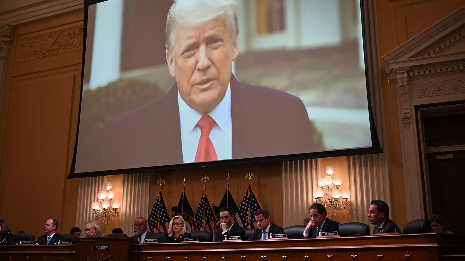 Video of Trump is displayed on a screen during the hearing on June 28.