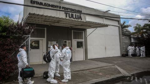 Members of Colombia's Technical Investigation Corps stand outside the prison in Tulua, Colombia on Tuesday, after dozens of inmates died after a prison riot.