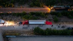 In this aerial view, members of law enforcement investigate a tractor trailer on June 27, 2022 in San Antonio, Texas. According to reports, at least 46 people, who are believed migrant workers from Mexico, were found dead in an abandoned tractor trailer. Over a dozen victims were found alive, suffering from heat stroke and taken to local hospitals. 