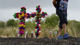 A man pays his respects at the site where officials found dozens of people dead in a semitrailer containing suspected migrants, Tuesday, June 28, 2022, in San Antonio. 