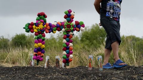 A man pays his respects at the site where officials found dozens of people dead inside a semi truck in San Antonio, Texas. 