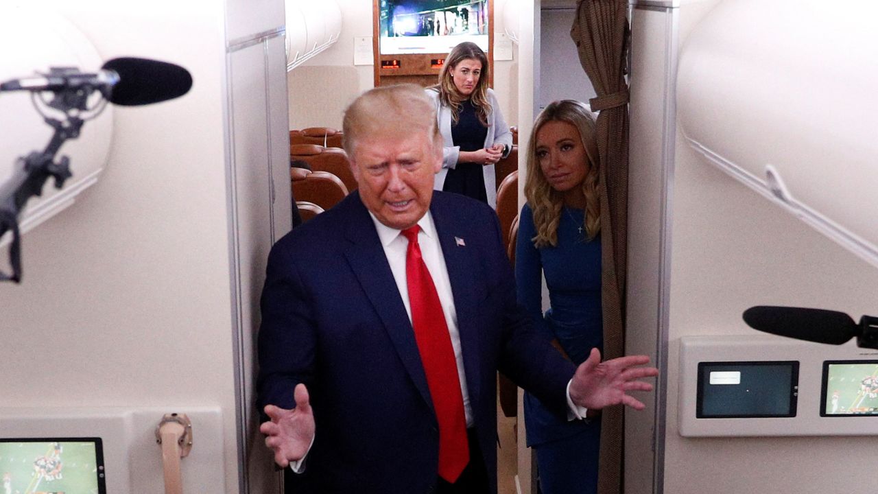 Cassidy Hutchinson and Press Secretary Kayleigh McEnany watch as President Trump speaks aboard Air Force One after a campaign event in Wisconsin